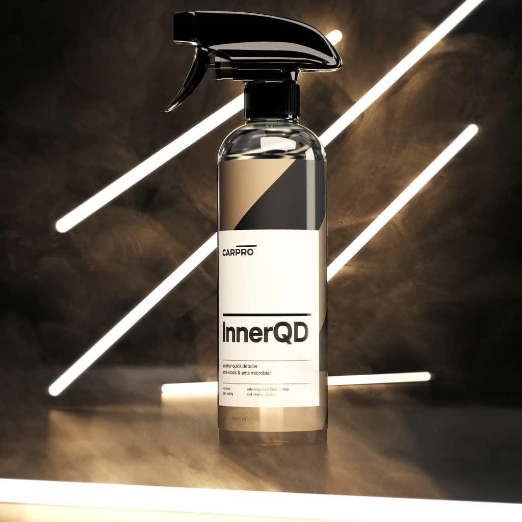 Planet Car Care CarPro InnerQD interior quick detailer spray bottle with a sleek label on a dark surface.