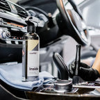 Planet Car Care CarPro Inside 500ml cleaner being used with a detailing brush on a car interior console