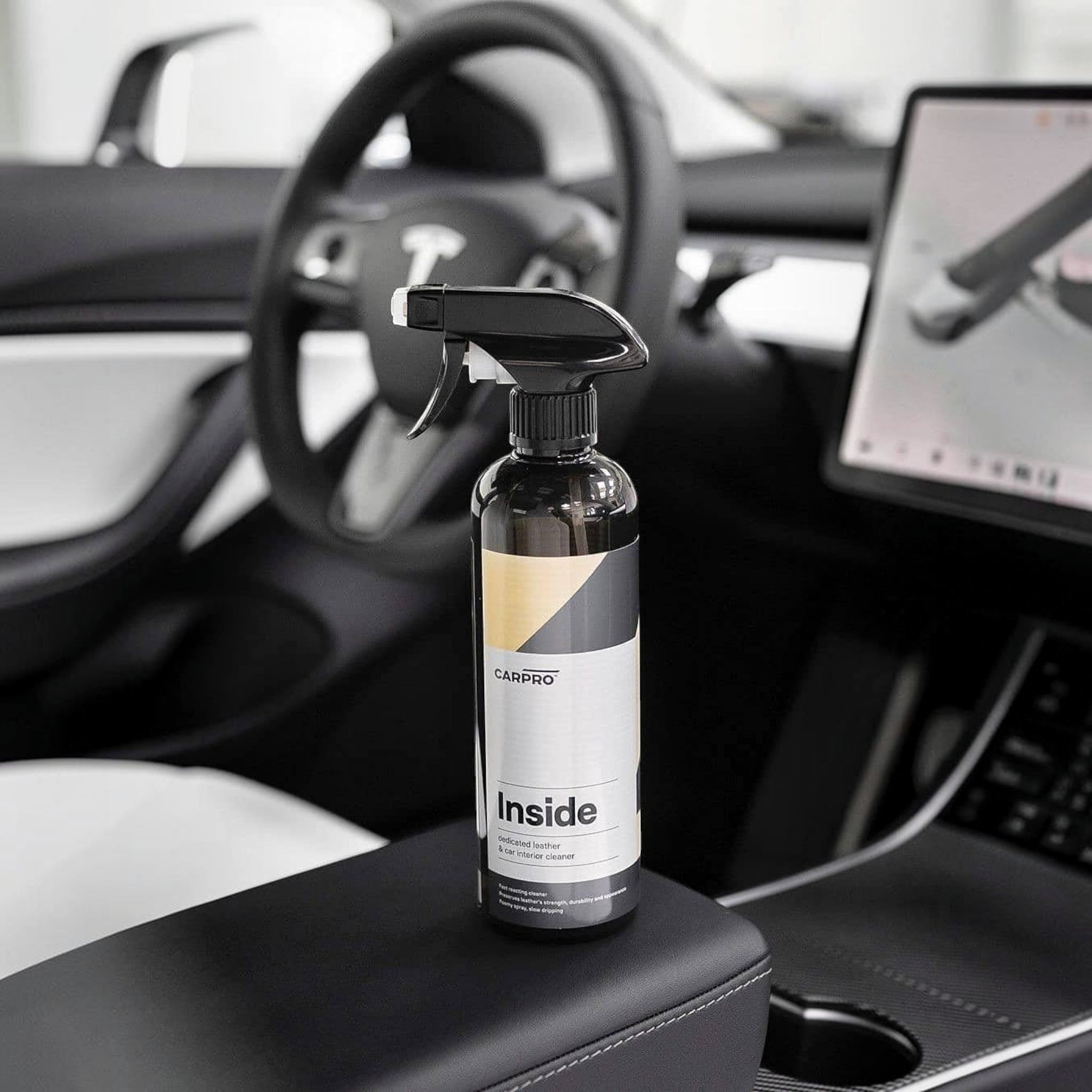Planet Car Care CarPro Inside 500ml interior cleaner spray bottle on a car center console