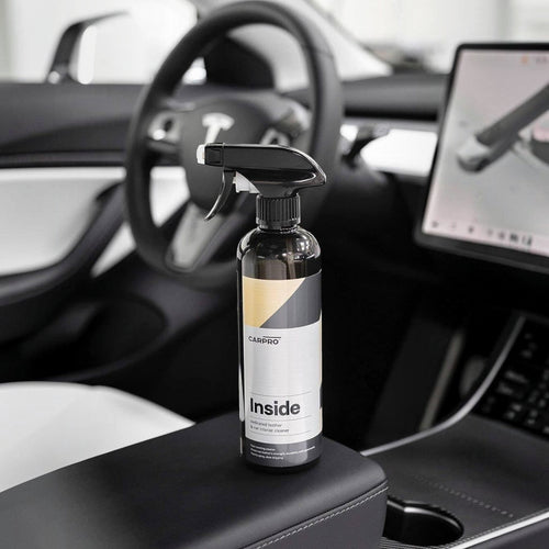 Planet Car Care CarPro Inside 500ml interior cleaner spray bottle on a car center console