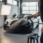 Planet Car Care CarPro Reload 2.0 spray sealant being applied to a luxury car in a professional detailing studio