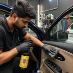 A detailer using Planet Car Care ClearPro all-purpose cleaner to wipe a car interior door panel with a microfiber cloth.