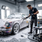 Planet Car Care technician using a foam cannon to apply thick snow foam shampoo to a classic car in a workshop