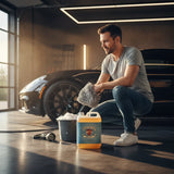 Planet Car Care Foam Fury snow foam shampoo 5L bottle next to a man washing a car in a professional garage