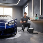 Planet Car Care Foam Fury snow foam shampoo bottle on a shelf next to a man washing a blue sports car in a garage.
