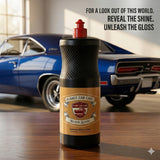 Planet Car Care Hyper Gloss premium liquid car wax bottle on a wooden table with a blurred blue classic car background