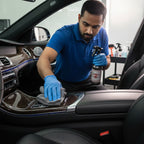 Planet Car Care professional detailing interior dresser being applied to a car dashboard with a microfiber cloth