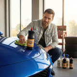 Planet Car Care user applying liquid wax to a blue car hood with a microfiber cloth for a high-gloss finish