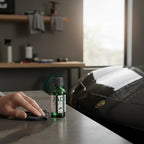 Planet Car Care Puris Jade Quartz 9H ceramic coating 50ml bottle on a workbench with a microfiber cloth and car hood