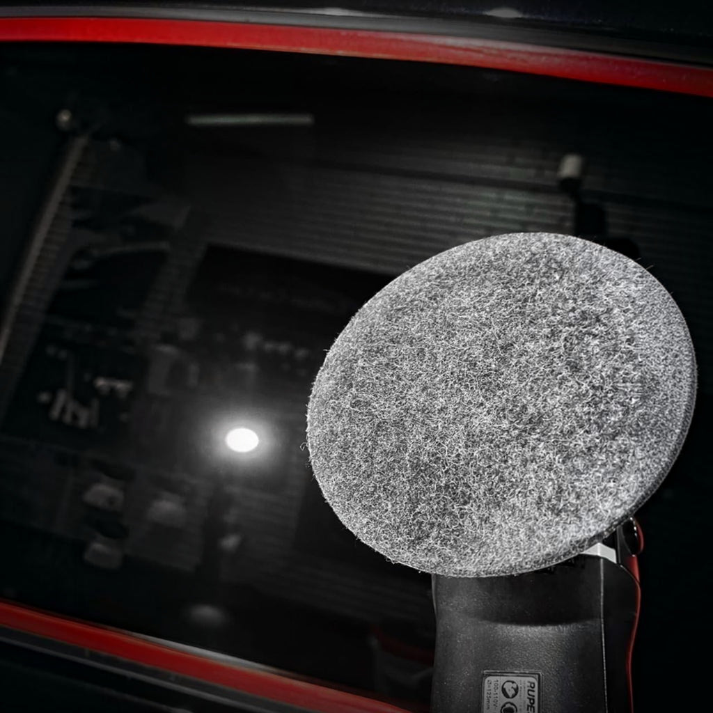 Planet Car Care CarPro rayon glass polishing pad attached to a buffer, used for removing water spots from car windows.