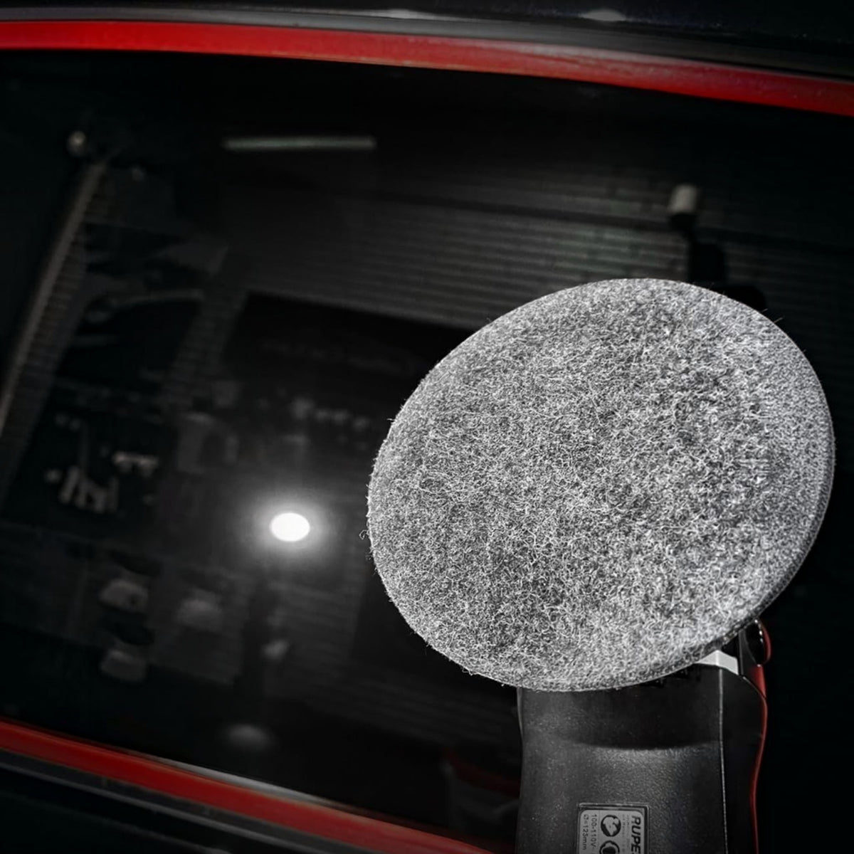 Planet Car Care CarPro rayon glass polishing pad attached to a buffer, used for removing water spots from car windows.