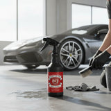 Planet Car Care Rim Raider non-acid wheel and tyre cleaner in a 750ml spray bottle held by a person in a garage.