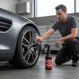 Planet Car Care Rim Raider non-acid wheel and tyre cleaner bottle next to a man cleaning a car wheel with a cloth.